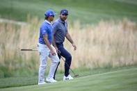 Rickie Fowler, left, and Jason Day, right, of, Australia, talk as they approach the 16th green during the first round of the Wells Fargo Championship golf tournament, Thursday, May 5, 2022, at TPC Potomac at Avenel Farm golf club in Potomac, Md. (AP Photo/Nick Wass)