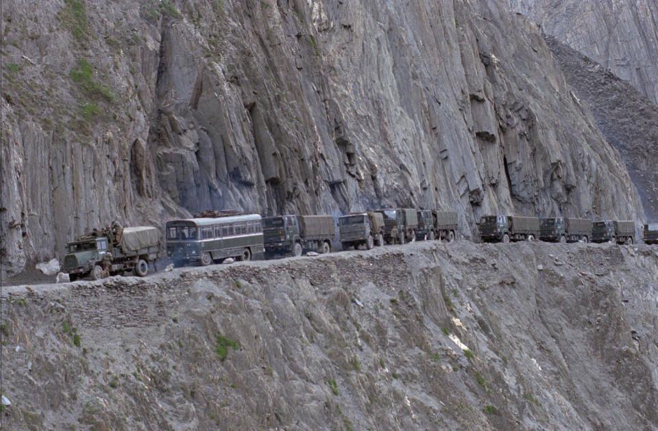 FILE - In this June 5, 1999, file photo, an Indian army convoy of reinforcement moves towards the Indian border town of Kargil, near Baltal, 110 kilometers (68 miles) north of Srinagar, in the northern Indian state of Jammu and Kashmir. India’s surprise move in August 2019, to carve out the sparsely populated region of Ladakh from the state of Jammu and Kashmir and make it into a territory directly controlled by New Delhi has been met with protests in Kargil, a Muslim-majority border city in Ladakh that identifies culturally with Kashmir, suggesting that the Hindu nationalist-led government’s plan to redraw the country’s political map will be far from easy. Kargil, nestled among sharp hillsides and rough terrain, is where India and Pakistan fought a war in 1999. (AP Photo/Aijaz Rahi, File)