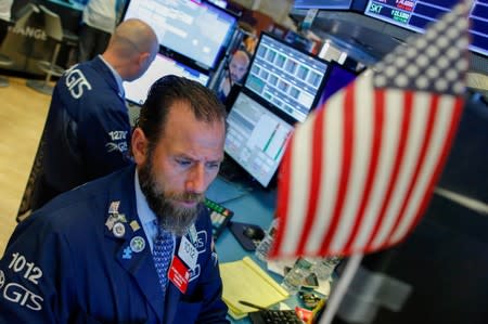 Traders work on the floor at the New York Stock Exchange (NYSE) in New York