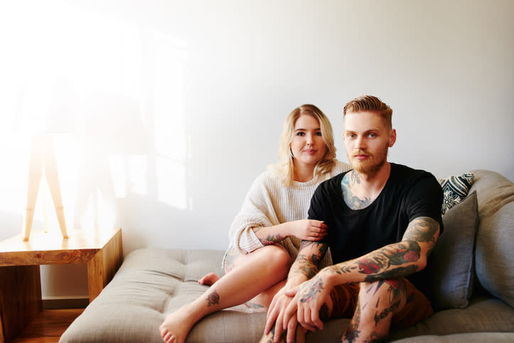 Portrait of a young couple relaxing at home.