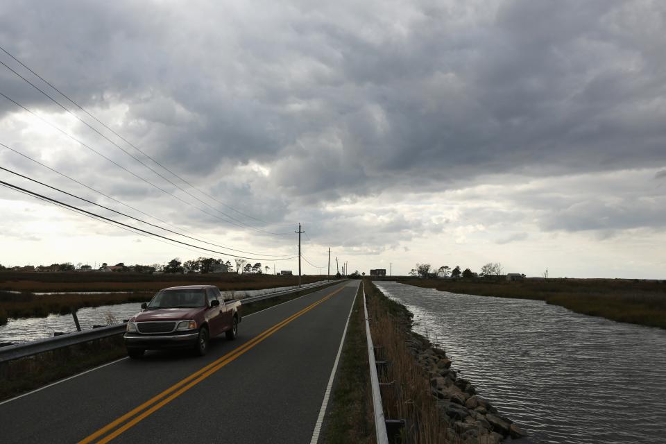 Water flanks the access road from Saxis Island in Virginia