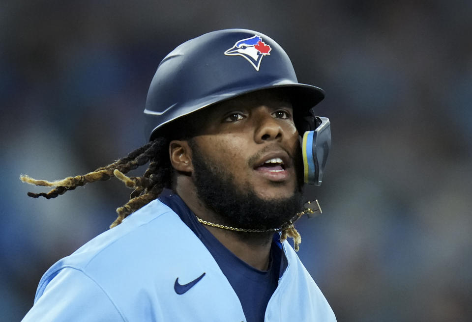 Toronto Blue Jays first baseman Vladimir Guerrero Jr. (27) gets walked to first base against the Seattle Mariners during the seventh inning of a baseball game in Toronto, Monday, May 16, 2022. (Nathan Denette/The Canadian Press via AP)