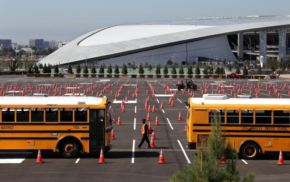 LAUSD buses line up in a "dry run" at SoFi Stadium in Inglewood on Friday.