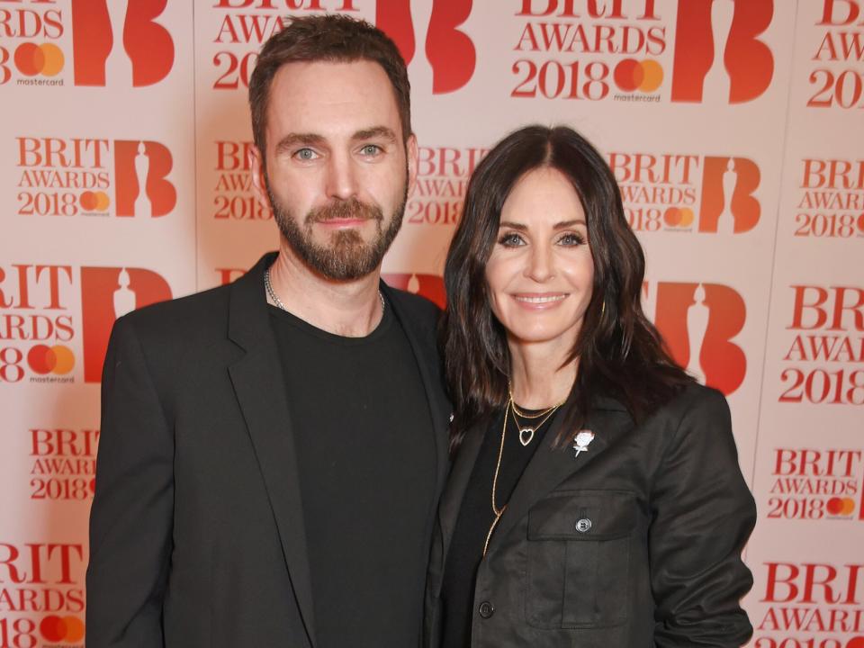 Johnny McDaid (L) and Courteney Cox attend The BRIT Awards 2018 held at The O2 Arena on February 21, 2018 in London, England