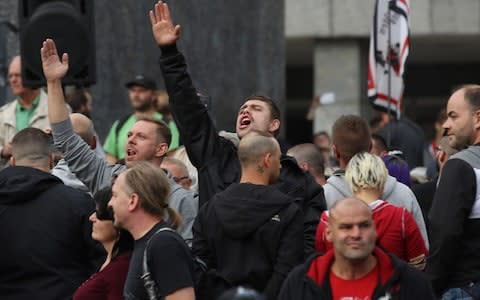 A man raises his arm in a Heil Hitler salute towards heckling leftists at a right-wing protest gathering the day after a man was stabbed and died of his injuries on August 27, 2018 in Chemnitz - Credit: Sean Gallup/Getty Images