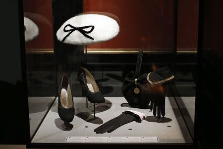 Gloves by Lionel Legrand, black pumps by Perugia, hat by Jeanne Blanchot and a handbag are presented in the exhibition "Les Annees 50, La mode en France" (The 50s. Fashion in France, 1947-1957) at the Palais Galliera fashion museum in Paris, July 10, 2014. REUTERS/Benoit Tessier