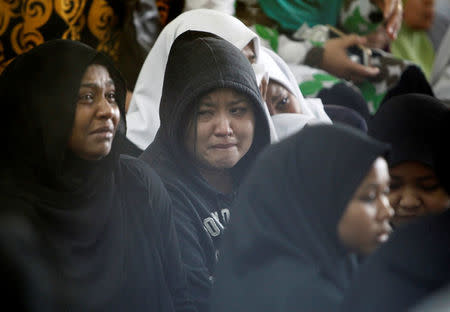 Family members wait for news of their loved ones outside religious school Darul Quran Ittifaqiyah after a fire broke out in Kuala Lumpur, Malaysia September 14, 2017. REUTERS/Lai Seng Sin