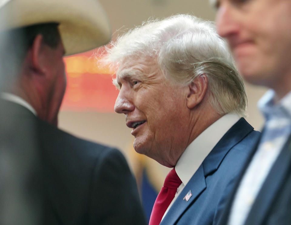 Former President Donald Trump greets attendees as he enters the room at a border security briefing at the Texas DPS Weslaco Regional Office on Wednesday, June 30, 2021, in Weslaco, Texas. (Joel Martinez/The Monitor via AP, Pool)