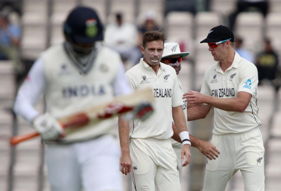 New Zealand's Tim Southee, center, celebrates with teammates the dismissal of India's Jasprit Bumrah, left, during the sixth day of the World Test Championship final cricket match between New Zealand and India, at the Rose Bowl in Southampton, England, Wednesday, June 23, 2021. (AP Photo/Ian Walton)