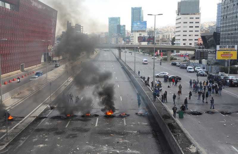 Demonstrators block a highway during a protest in Jal el-Dib