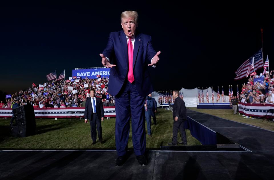 Former President Donald Trump acknowledges the crowd as he walks on stage during a campaign rally for Republican candidate for governor Tim Michels at the Waukesha County Fairgrounds in Waukesha August 5, 2022.