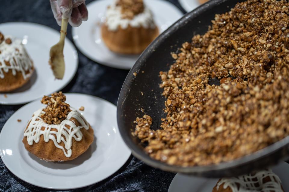 Caramel-candied nuts are added to a rum bun cake during the Detroit Free Press/Metro Detroit Chevy Dealers' Top 10 Takeover.