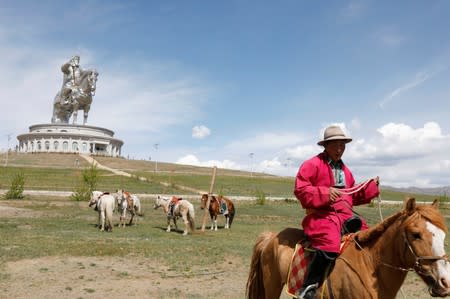 Worker rides a horse for tourists at the Genghis Khan Statue Complex east of Ulaanbaatar