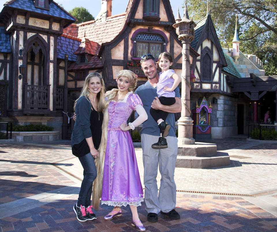 Sarah Michelle Gellar, Freddie Prinze Jr. and their daughter Charlotte, 3, meet Rapunzel at the all-new 'Fantasy Faire' attraction at Disneyland park in Anaheim, Calif., on Wednesday, March 6, 2013. (AP Photo/Disneyland, Paul Hiffmeyer)