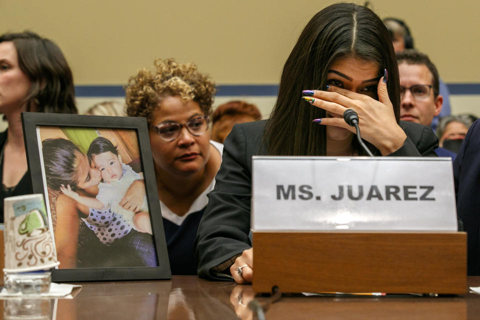 Yazmin Juárez, reacts as a photos of her daughter, Mariee, 1, who died after being released from detention by U.S. Immigration and Customs Enforcement, is placed next to her at a House Oversight subcommittee hearing on Civil Rights and Civil Liberties to discuss treatment of immigrant children at the southern border, Wednesday, July 10, 2019, on Capitol Hill in Washington. (AP Photo/Jacquelyn Martin)