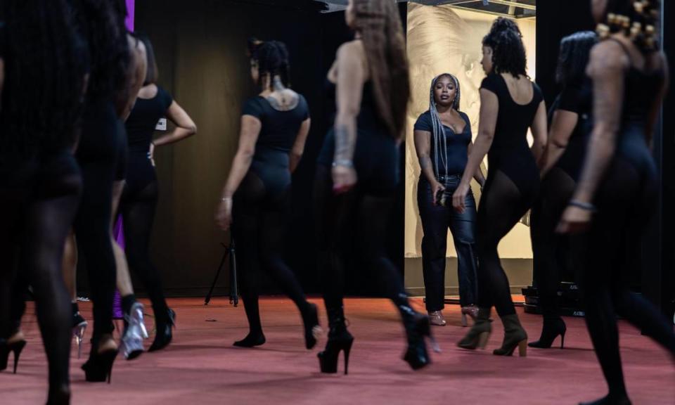 Amiah Nicks, back, owner of Millionaire Social, observes choreography during a class at her business at the Long Creek Shopping Center.