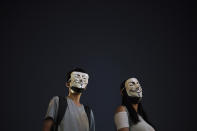Protesters wear masks during a protest in Hong Kong, Friday, Oct. 18, 2019. Hong Kong pro-democracy protesters are donning cartoon/superhero masks as they formed a human chain across the semiautonomous Chinese city, in defiance of a government ban on face coverings. (AP Photo/Felipe Dana)