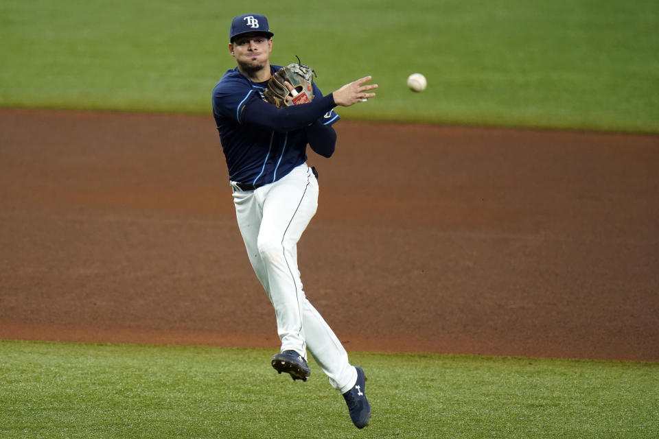 Tampa Bay Rays shortstop Willy Adames throws out Philadelphia Phillies' Roman Quinn at first base during the fifth inning of a baseball game Saturday, Sept. 26, 2020, in St. Petersburg, Fla. (AP Photo/Chris O'Meara)