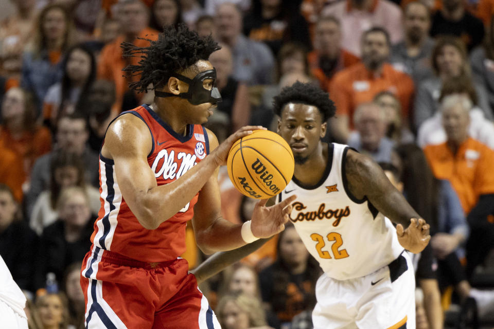 Oklahoma State's Kalib Boone (22) guards against Mississippi's Jayveous McKinnis, left, during the first half of an NCAA college basketball game in Stillwater, Okla., Saturday, Jan. 28, 2023. (AP Photo/Mitch Alcala)