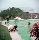 <p>Actress Dolores del Río lounges by a pool with friends while in Acapulco in 1952. </p>