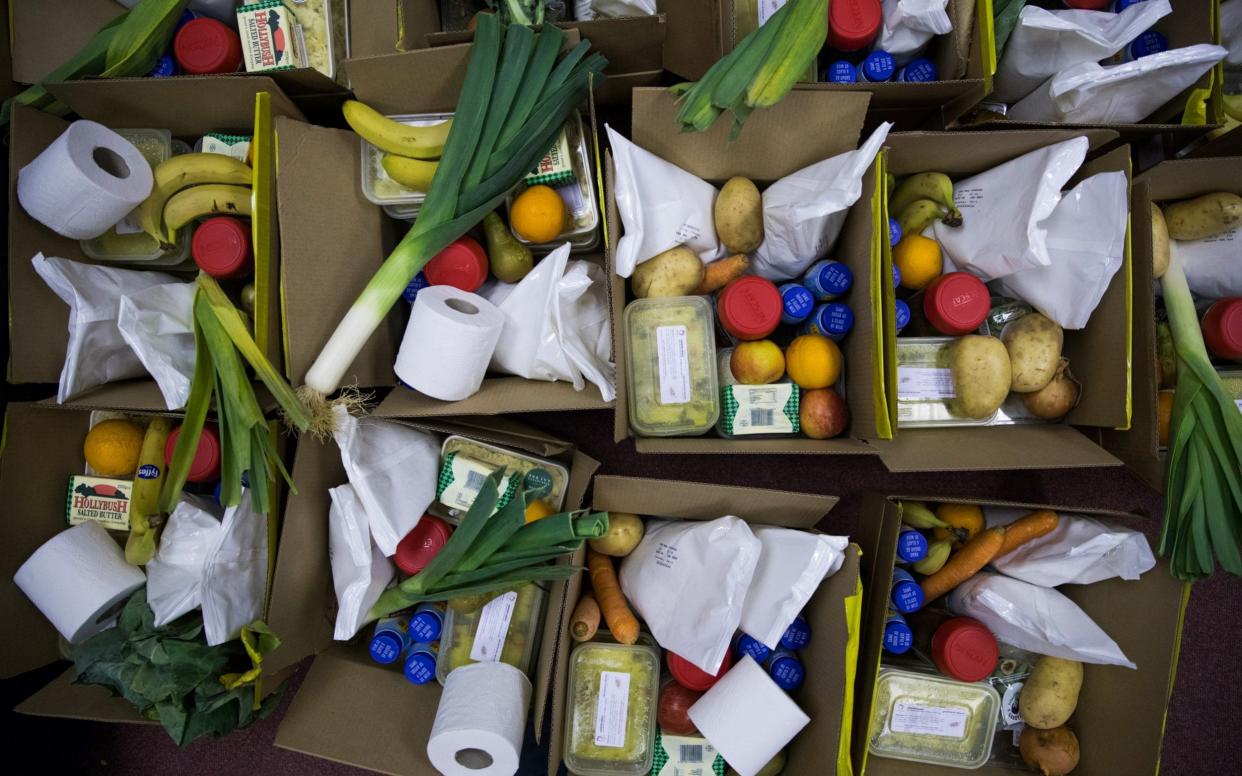Boxes of food and toiletries sit on the floor waiting to be collected from the food bank run by Dads House charity in London - Chris Ratcliffe /Bloomberg