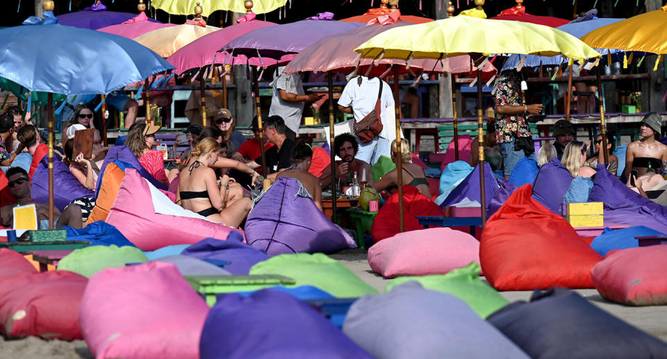 Bali tourists on beach chairs