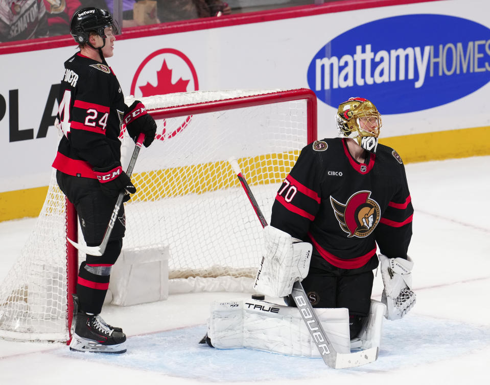 Ottawa Senators defenseman Jacob Bernard-Docker (24) and goaltender Joonas Korpisalo (70) react after a goal by the Anaheim Ducks during third-period NHL hockey game action in Ottawa, Ontario, Thursday, Feb. 15, 2024. (Sean Kilpatrick/The Canadian Press via AP)