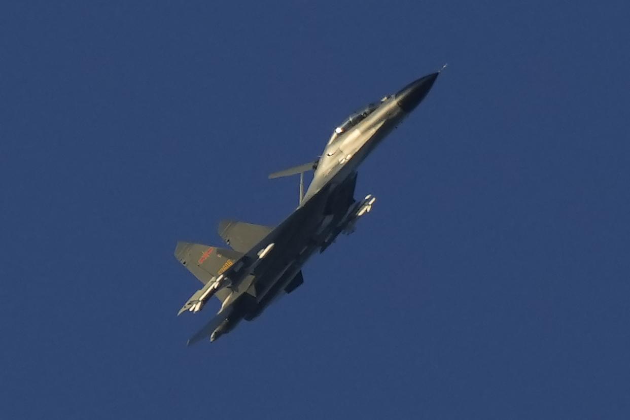 A Chinese J-11 military fighter jet flies above the Taiwan Strait near Pingtan, the closest land of mainland China to the island of Taiwan, in Pingtan in southeastern China's Fujian Province, Friday, Aug. 5, 2022. 