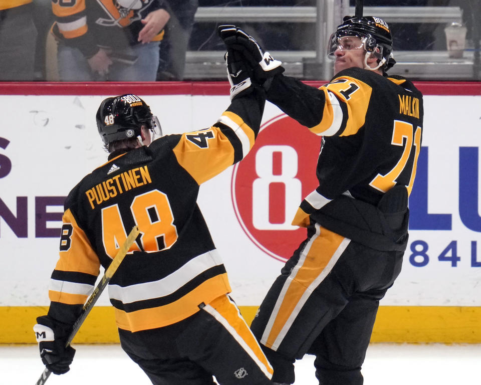 Pittsburgh Penguins' Evgeni Malkin (71) celebrates with Valtteri Puustinen after Malkin scored against the Columbus Blue Jackets during the first period of an NHL hockey game in Pittsburgh, Tuesday, March 5, 2024. (AP Photo/Gene J. Puskar)