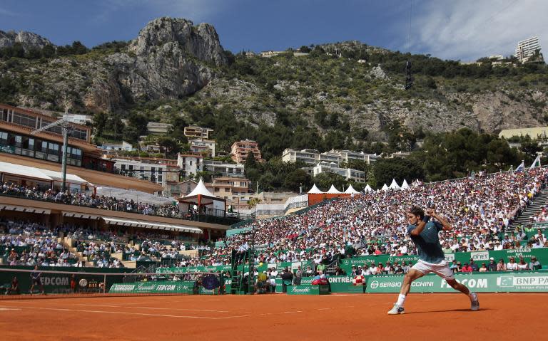 Switzerland's Roger Federer returns the ball to Czech Republic's Lukas Rosol on April 17, 2014 during their Monte-Carlo ATP Masters Series Tournament tennis match in Monaco