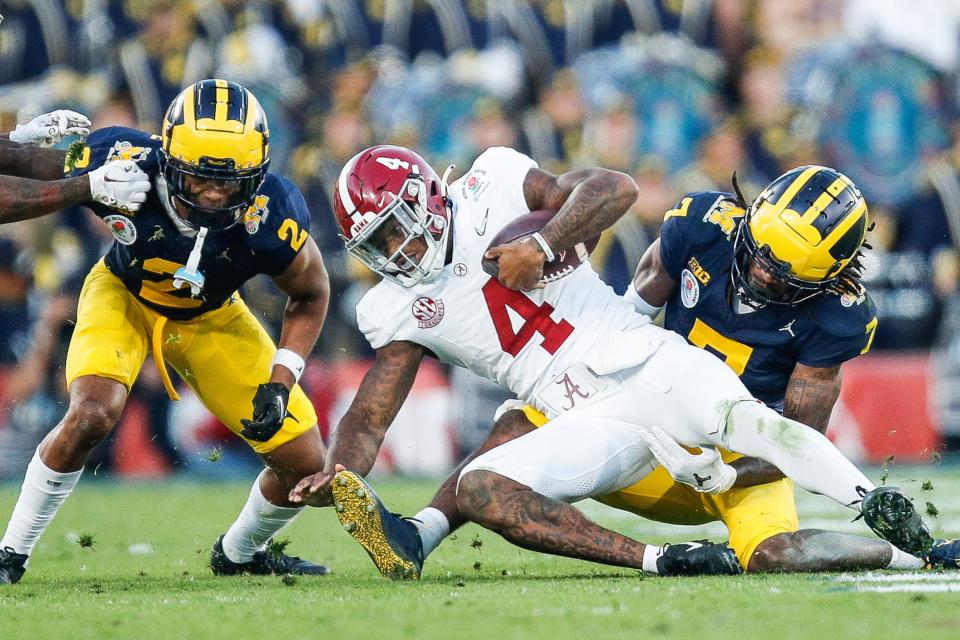 Alabama quarterback Jalen Milroe (4) runs against Michigan defensive back Makari Paige (7) during the second half of the Rose Bowl in Pasadena, Calif., on Monday, Jan. 1, 2024.