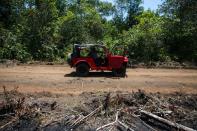A parked car is seen on an illegal road in a deforested area of the Yari plains, in Caqueta