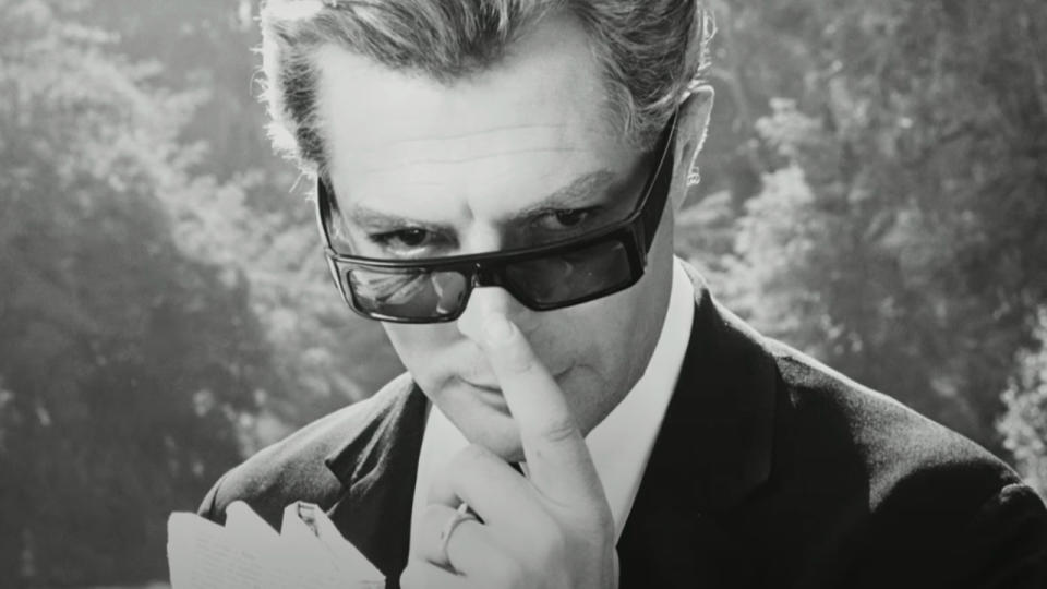 Marcello Mastroianni tapping his nose slyly in La Dolce Vita.