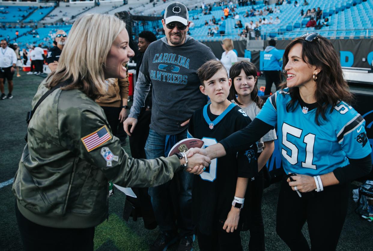 Panthers president Kristi Coleman (left) greeting fans prior to the team's football game.