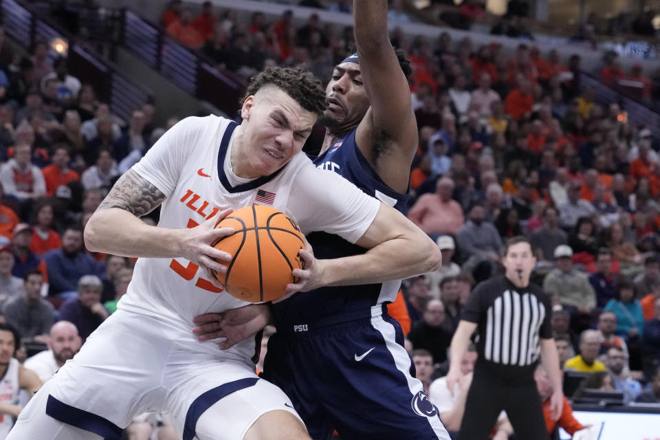 Illinois's Coleman Hawkins drives to the basket as Penn State's Jalen Pickett defends during the second half of an NCAA college basketball game at the Big Ten men's tournament, Thursday, March 9, 2023, in Chicago. Penn State won 79-76. (AP Photo/Charles Rex Arbogast)