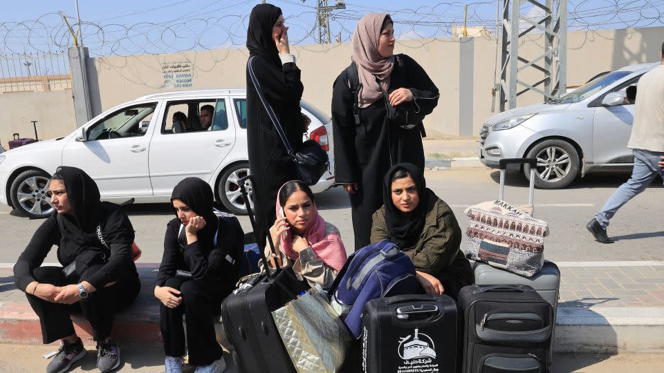 People carrying foreign passports wait at the Rafah gate hoping to cross into Egypt as Israel's attacks on the Gaza Strip continues on October 14, 2023. - Said Khatib/AFP/Getty Images