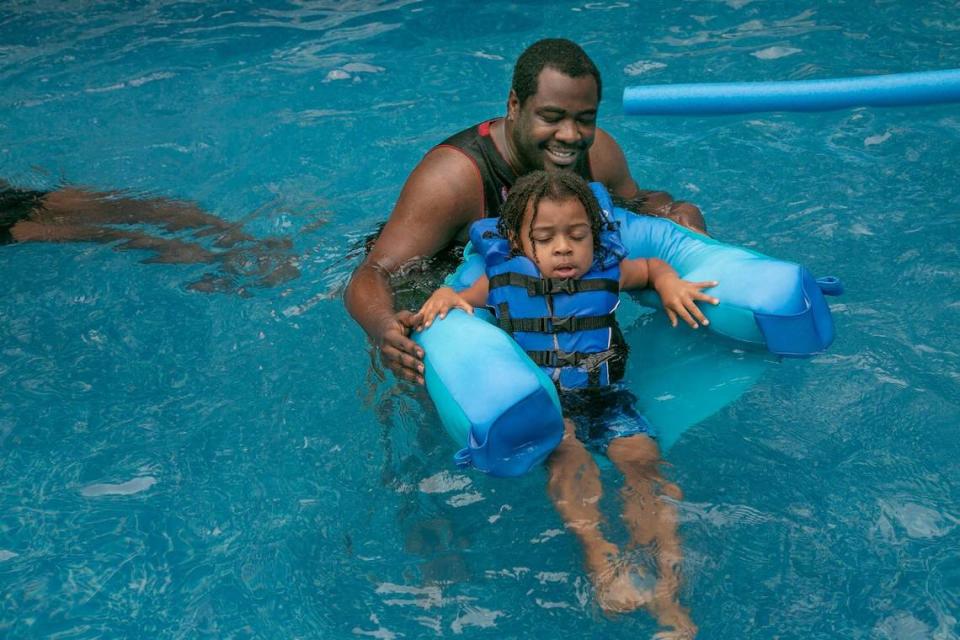 Chuck Hubbard and his son, Mykel, swim in Deb Frey’s Prairie Village pool.