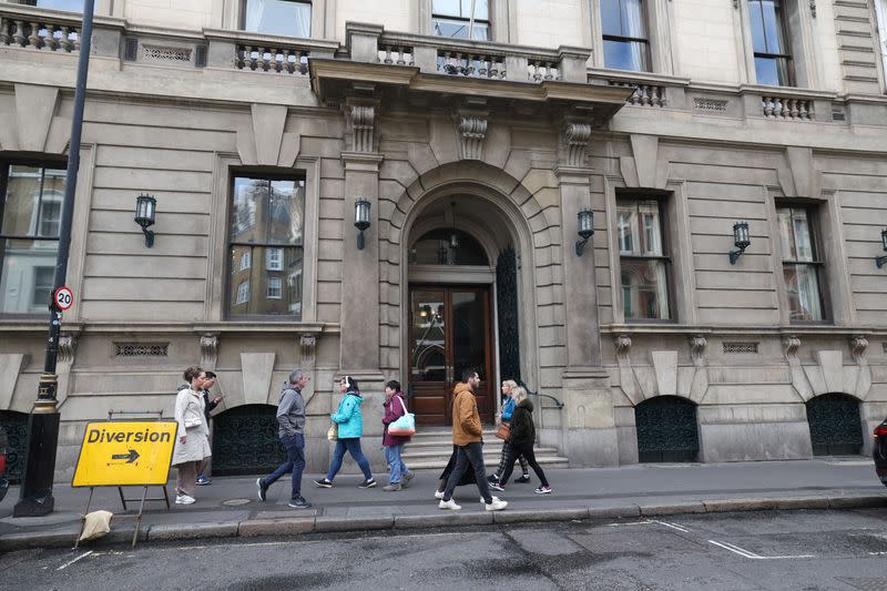 People walk past the entrance to the Garrick Club in London