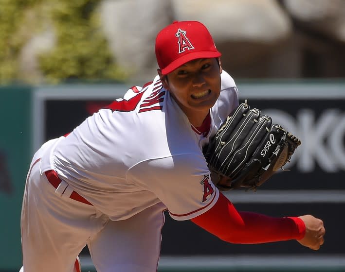 FILE - In this Aug. 2, 2020, file photo, Los Angeles Angels pitcher Shohei Ohtani, of Japan, throws during the second inning of a baseball game against the Houston Astros in Anaheim, Calif. Ohtani agreed to a two-year, $8.5 million contract with the Angels on Monday, Feb. 8, 2021, avoiding arbitration. (AP Photo/Mark J. Terrill, File)