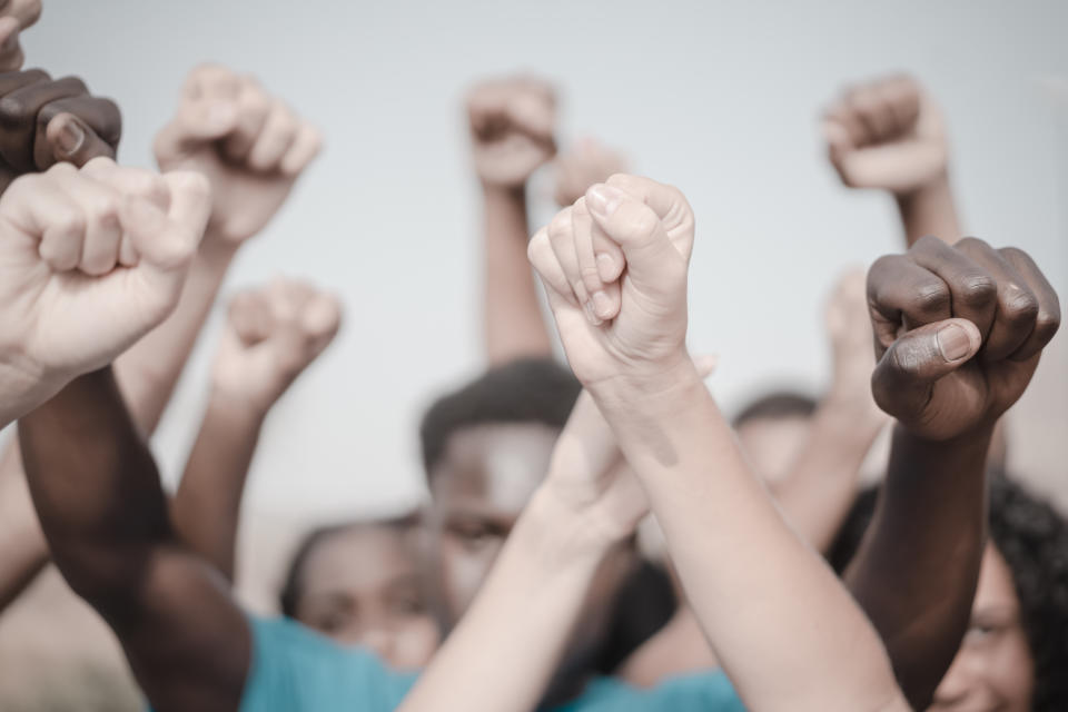 People raised fist air fighting for their rights. Labor movement, election movement, no racism and union concept. Image