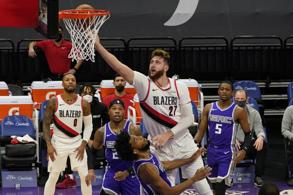 Portland Trail Blazers center Jusuf Nurkic, right, goes to the basket over Sacramento Kings forward Marvin Bagley III, foreground center, during the first quarter of an NBA basketball game in Sacramento, Calif., Wednesday, Jan. 13, 2021. (AP Photo/Rich Pedroncelli)