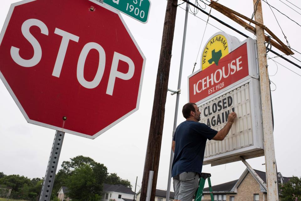 Bar owner Petros J Markantonis changes the marquee outside his bar to 