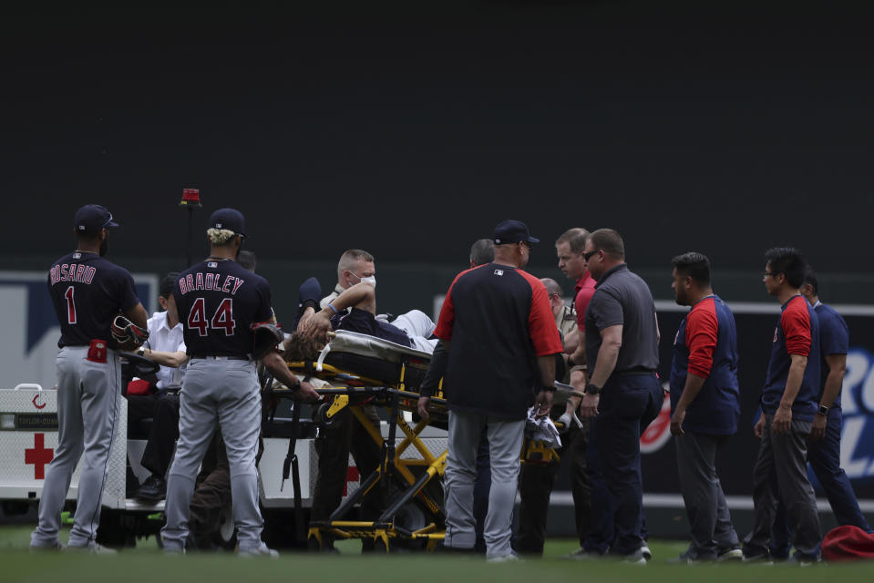 Cleveland Indians' Josh Naylor (22) is surrounded by Indians medial staff after colliding with a teammate during the fourth inning of a baseball game against the Minnesota Twins, Sunday, June 27, 2021, in Minneapolis. (AP Photo/Stacy Bengs)