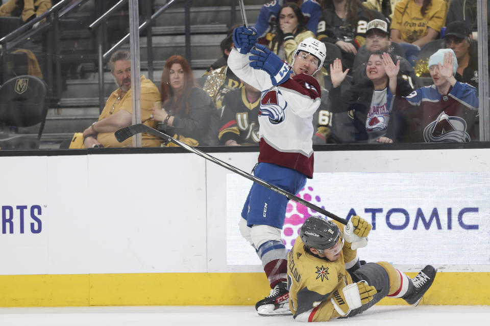 Vegas Golden Knights defenseman Zach Whitecloud (2) falls after colliding with Colorado Avalanche right wing Brandon Duhaime (12) during the third period of an NHL hockey game Sunday, April 14, 2024, in Las Vegas. (AP Photo/Ian Maule)