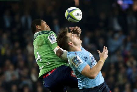 Bernard Foley (R) from the New South Wales Waratahs jumps to catch the ball with Waisake Haholo from New Zealand's Highlanders during their Super Rugby semi-final match at the Sydney Football Stadium, Australia, June 27, 2015. REUTERS/David Gray