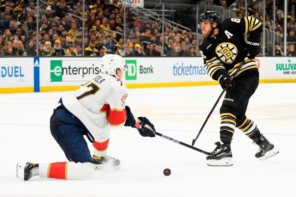May 12, 2024; Boston, Massachusetts, USA; Boston Bruins right wing David Pastrnak (88) passes the puck past Florida Panthers defenseman Niko Mikkola (77) during the third period in game four of the second round of the 2024 Stanley Cup Playoffs at TD Garden.