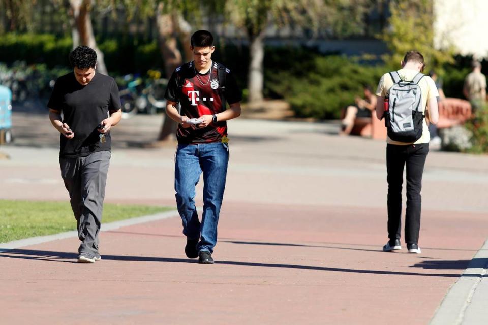 Students at Cal Poly in San Luis Obispo walk to and from classes in February 2022.