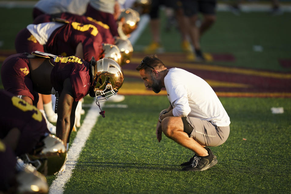 Minnesota defensive coordinator Joe Rossi, right, speaks with linebacker Braelen Oliver, left center, during an NCAA college football practice in Minneapolis, Aug. 12, 2021. Minnesota defensive coordinator Rossi has accepted the same job at Michigan State under new coach Jonathan Smith, according to a person with knowledge of the move. The person confirmed Rossi's departure to The Associated Press, Monday, Dec. 11, 2023. The person spoke on condition of anonymity because Michigan State had not yet announced the hire. (Renee Jones Schneider/Star Tribune via AP)