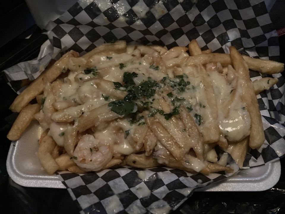 The Shrimp Alfredo fries ($10) from Dia de los Pescados are a cheesy, good concoction. And it's enough for two.