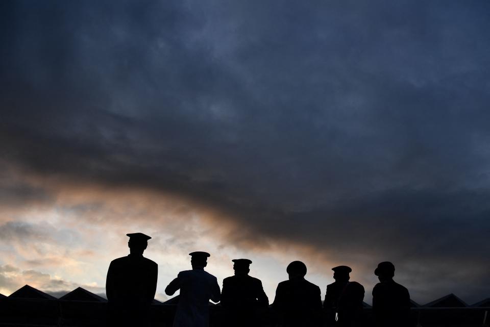 <p>Officials look on as they attend the medal ceremony for the men's cycling road race of the Tokyo 2020 Olympic Games, at the Fuji International Speedway in Oyama, Japan. (Photo by Jeff PACHOUD / AFP)</p> 